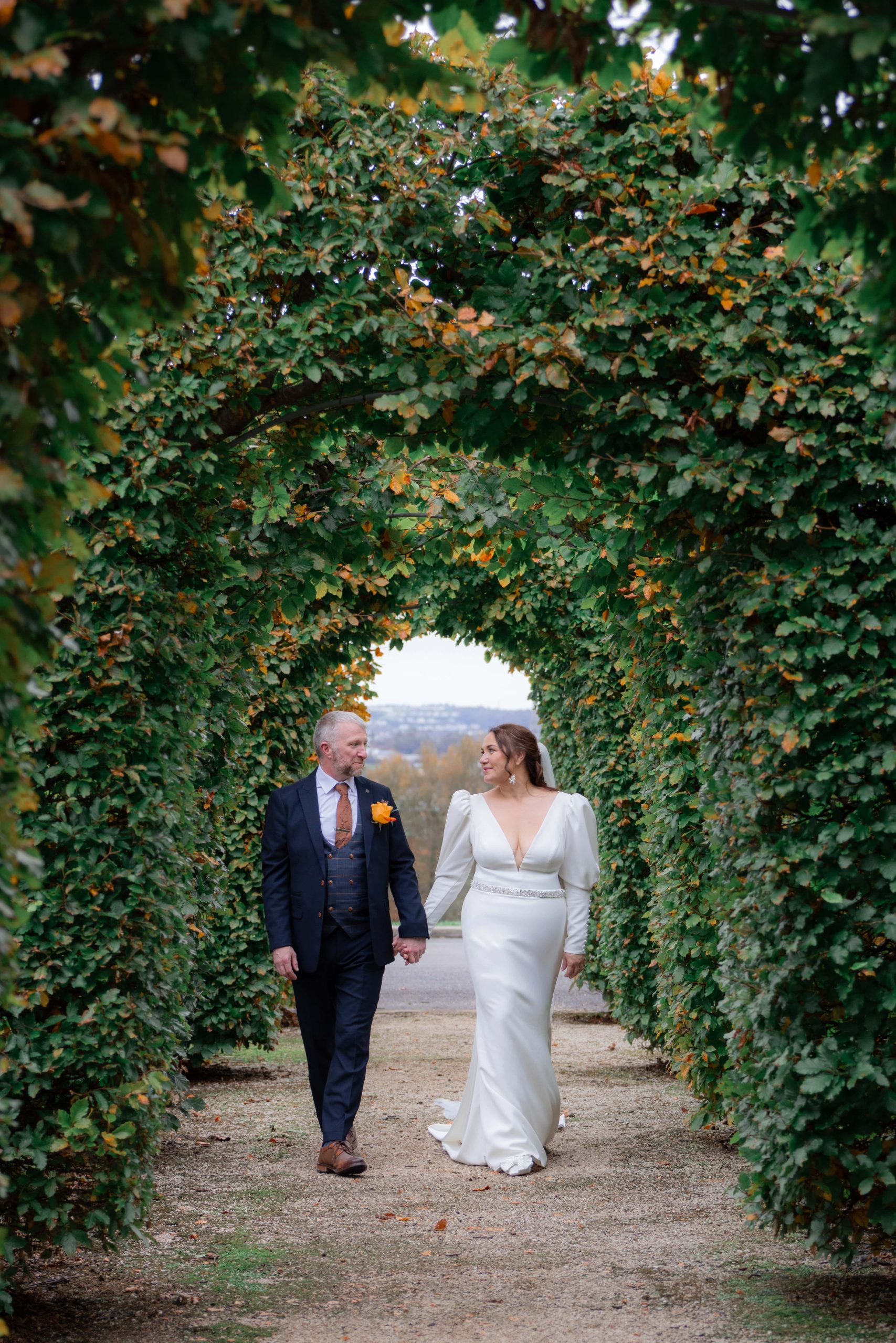 couple holding hands walking in ireland